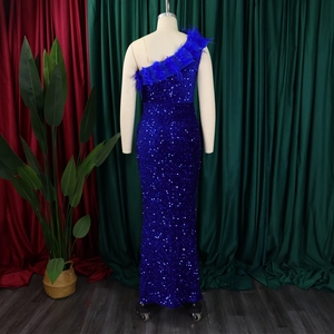 Detail eines blauen Paillettenkleides mit luxuriösem Federbesatz am One-Shoulder-Ausschnitt