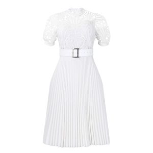 Detailed view of the white lace stitching and pleated texture on this elegant dress
