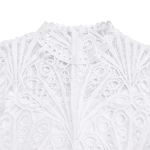 Close-up of white lace dress featuring a high stand collar and delicate floral embroidery