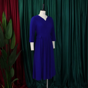 Detail view of royal blue V-neck dress featuring pleated skirt and waist pocket button detail