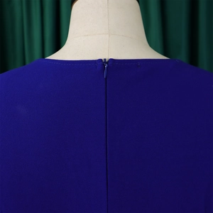 Close-up of invisible zipper and pleated neckline on blue solid color chiffon dress