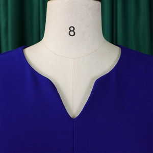 Detail of V-neckline on royal blue textured dress with three-quarter sleeves