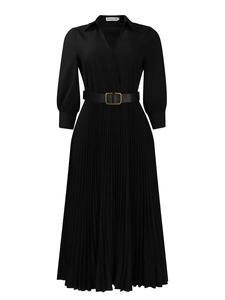 Detail of waist design showing black pleated dress with leather belt and gold buckle