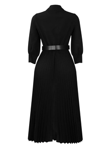Back view of elegant black long sleeve pleated midi dress with minimalist waist belt
