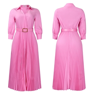 Detail of pink pleated maxi dress with gold buckle belt and long cuffed sleeves