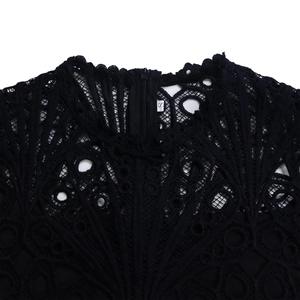 Detailed view of black lace neckline with sheer patterns and hidden zipper closure