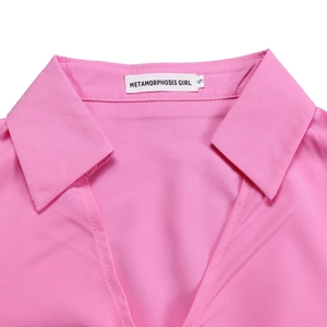 Detail of pink long-sleeve shirt collar with woven brand label and size S tag