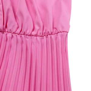 Detailed close-up of high waist pleats and fabric texture on a bright pink dress
