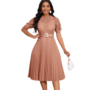 Detail of rose pink lace stitching and pleated fabric on an elegant African dress