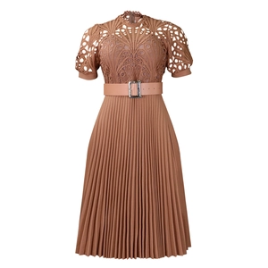 Detail of delicate lace bodice and pleated skirt on a vintage brown African dress