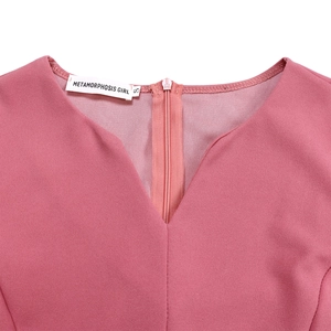 Close-up of V-neckline and back invisible zipper on mauve pink pleated dress