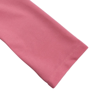 Detailed close-up of pink dress sleeve showing fine fabric texture and neat double stitching