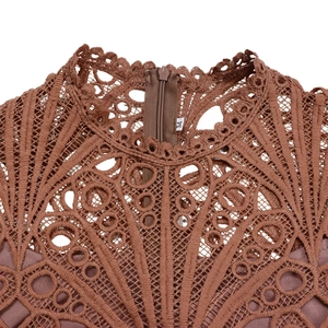 Macro detail of the brown lace neckline and zipper on this African dress
