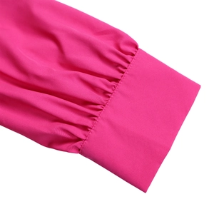 Detail of magenta sleeve cuff with gathered pleated design and high-density cotton texture