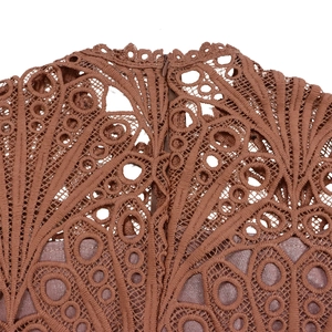 Detail of brown lace stitching and invisible zipper on the back of an African dress