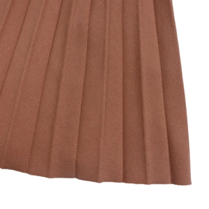 Detailed macro view of the brown pleated fabric texture on this elegant dress