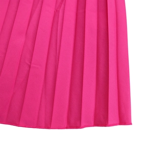 Detail of hot pink pleated fabric and precise hem stitching on the long sleeve dress