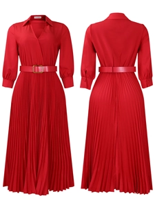 Detail of red pleated long sleeve dress featuring lapel collar and golden waist buckle