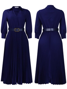 Detail of navy blue pleated dress featuring V-neck collar and gold buckle waist belt