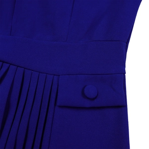 Detail view of dark blue pleated dress featuring high waist cut and buttoned pocket flap