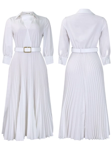 Detail of white pleated long sleeve dress featuring an elegant collar and belted waistline