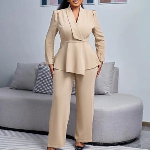 Detail of elegant beige peplum blazer sleeve featuring delicate button decorations