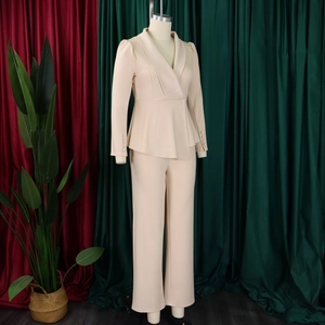 Detail of elegant beige shawl collar blazer with fitted waist and tailored sleeves