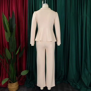 Back view of elegant beige suit set with peplum top and trousers on a mannequin