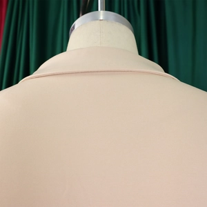 Detail of elegant beige blazer collar with high-quality textured woven fabric texture