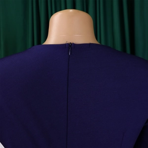 Detail of the back neck with invisible zipper on navy blue slim fit pencil dress