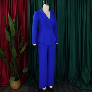 Detail view of electric blue peplum waist blazer and straight leg trousers two-piece set