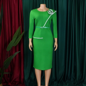 Detail of green long-sleeve dress with white spiral flower trim and matching belt
