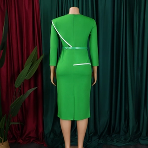 Detail view of emerald green bodycon dress with white asymmetric trim and back zipper