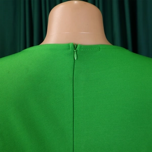 Detail of the emerald green pencil dress featuring a seamless concealed back zipper