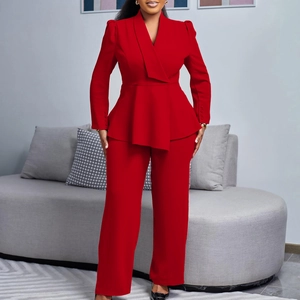 Detail of red two-piece suit set featuring ruffle hem waist and classic buttoned cuffs