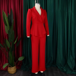 Detail of red peplum blazer with decorative fabric buttons and sharp notched lapels