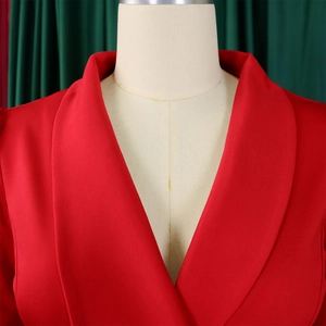Detail of red blazer with shawl collar, featuring textured fabric and sharp tailoring