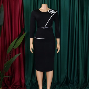 Detail of slim fit black dress with 3/4 sleeves and asymmetric white spiral floral design