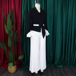 Detail of elegant two-piece set with flare sleeve top and pleated wide leg pants