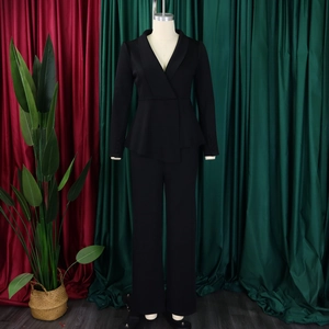 Detail of elegant black blazer with shawl lapel and stylish ruffle hem design