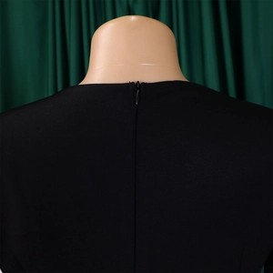 Detail view of a black pencil dress featuring a seamless invisible zipper on the back