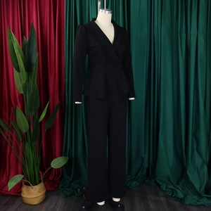 Detail of elegant black two-piece women's business suit with V-neck blazer and trousers
