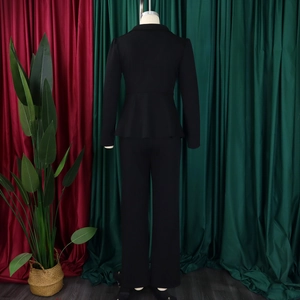 Formal black two-piece suit with waist-defined blazer and straight trousers on mannequin