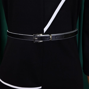 Detail of a black and white contrast leather belt with a silver square buckle on a dress