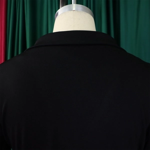 Detailed view of the back collar and shoulder of this elegant black ruffle suit jacket