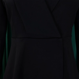 Detail of elegant black V-neck top with slimming waist seam and premium textured fabric