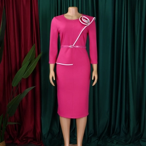 Detail of rose red bodycon dress featuring white floral shoulder accent and slim waist belt