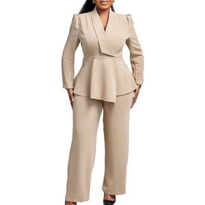 Detail of elegant beige two-piece suit featuring ruffled waist and buttoned sleeve cuffs