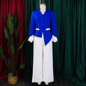 Detail of royal blue blazer with pleated sleeves and matching white wide leg trousers