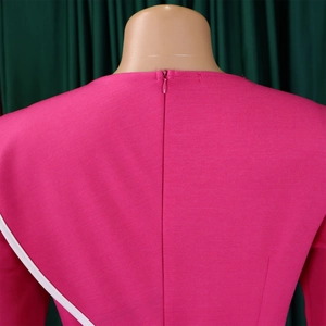 Detail of rose red dress back with invisible zipper and white decorative tape trim